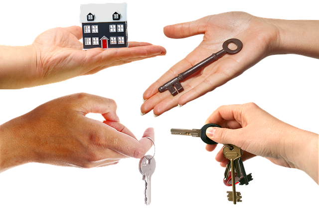 house key with keychain on mortgage document representing first time home purchase